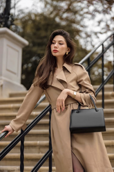 a lady in a brown trench coat